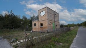 a building with a window on the side of a road at Holzhaus am Bergheider See in Buschmühle