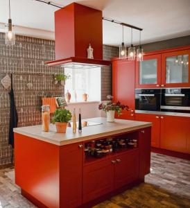 a kitchen with red cabinets and a counter at Gutshaus Gevezin in Blankenhof