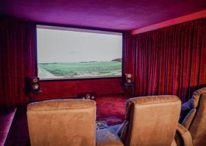 a train room with chairs and a large window at Gutshaus Gevezin in Blankenhof +31 photos