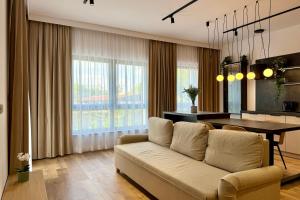 a living room with a couch and a table at Apartament Stara Fabryka 3 in Włocławek +2 photos