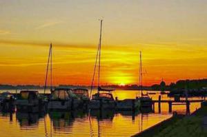 a group of boats parked in a marina at sunset at Ferienwohnung Amelie in Ribnitz-Damgarten