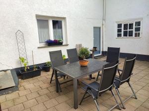 a table and chairs sitting on a patio at Ferienwohnung Amelie in Ribnitz-Damgarten