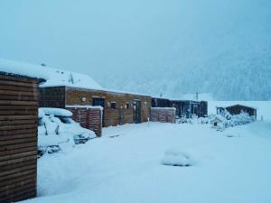 a house covered in snow in the snow at FREE Ride cabins in Tösens