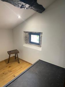 a room with a table and a small window at Ferme Fleurie in Bergesserin