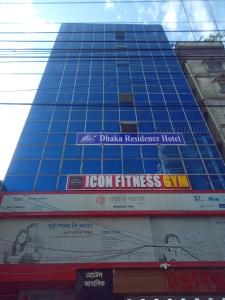 a tall blue building with a sign on it at Dhaka Residence Hotel in Dhaka