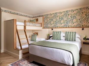a bedroom with two bunk beds and a staircase at The Ashe Hotel in Tralee