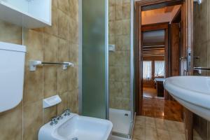 a bathroom with a sink and a toilet at Ciase Ai Ronch in Falcade