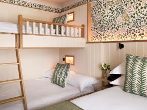two bunk beds in a dorm room with a ladder at The Ashe Hotel in Tralee
