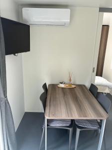 a dining room with a wooden table and chairs at Greilitz 23 in Gailitz
