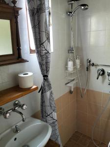 a shower curtain in a bathroom with a sink at La baita alpina in Scopello +24 photos