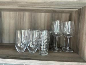 four empty wine glasses sitting on a shelf at Greilitz 23 in Gailitz