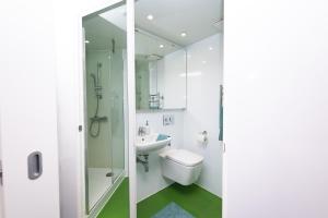 a bathroom with a toilet sink and a shower at Stephen's Quarter - Aparto in Dublin