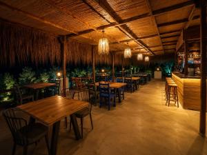 a restaurant with tables and chairs and a bar at Alya Hill Bodrum in Bodrum City
