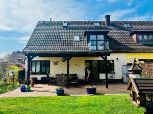 a house with a patio and a roof at Ferienwohnung "Baum" in Rechlin