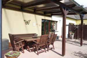 a wooden table and chairs on a patio at Ferienwohnung "Baum" in Rechlin