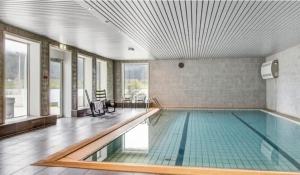 a swimming pool in a building with a swimming pool at Oppheim apartment, shared Pool & Sauna in Vossevangen