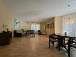 a living room with a table and a couch at Good Hostel Prishtina in Prishtinë