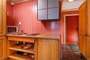 a kitchen with a sink and a microwave at Hafjell apartment, Ilsetra in Øyer