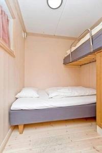 a bed in a room with two bunk beds at Hafjell apartment, Ilsetra in Øyer +9 photos