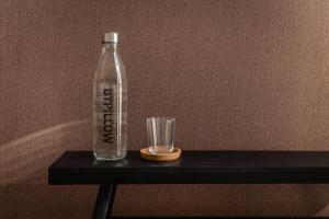 a bottle and a glass on a table at BYPILLOW Del Presto in Florence