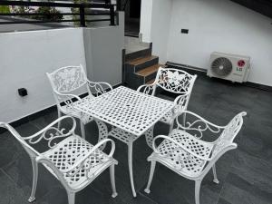 a table and chairs on a balcony with a heater at Jungle Breeze Villa in Melsiripura