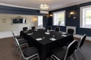 a meeting room with a black table and chairs at Aston Hall Hotel, BW Signature Collection in Sheffield