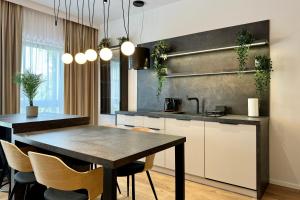 a kitchen with a table and chairs in a room at Apartament Stara Fabryka 3 in Włocławek