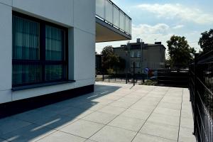 a building with a walkway next to a building at Apartament Stara Fabryka 3 in Włocławek