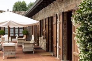 an outdoor patio with chairs and an umbrella at Relaisfranciacorta in Corte Franca