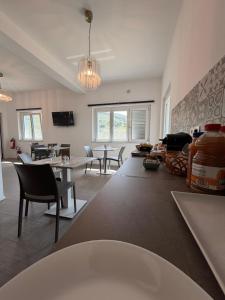 a living room with tables and chairs and a couch at B&B Nido degli Ulivi in Catanzaro
