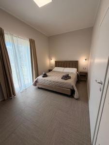 a bedroom with a bed and a large window at B&B Nido degli Ulivi in Catanzaro