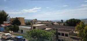 a city with cars parked in a parking lot at La Cattolica in Stilo +6 photos