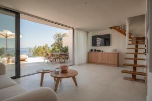 a living room with a view of a kitchen and a table at Maritima Villas in Paliouri