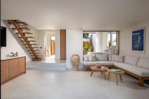 a living room with a couch and a table at Maritima Villas in Paliouri