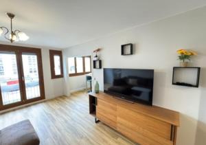 a living room with a large flat screen tv at T5 cosy lumineux in Amiens