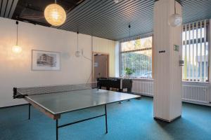 an empty room with a ping pong table in it at Atelier Probst Schönwald in Aufʼm Bühl