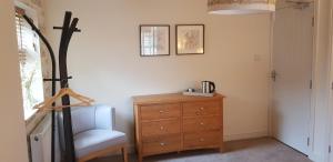 a room with a dresser and a chair next to a dresser at The Star Inn in North Dalton