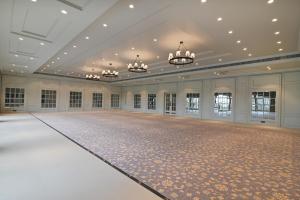 an empty ballroom with a dance floor and chandeliers at The Haven by Sula in Nashik