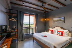 a bedroom with a bed and a balcony at Moustache Hostel Lonavala in Malavli