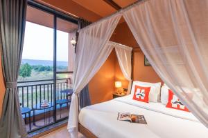 a bedroom with a bed and a balcony at Moustache Hostel Lonavala in Malavli