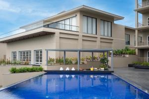 a house with a swimming pool in front of it at The Haven by Sula in Nashik