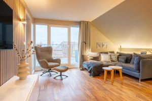 a living room with a couch and a chair at Riff5 Wohnung 6 in Borkum