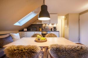 a kitchen with a table with a bowl of fruit on it at Riff5 Wohnung 6 in Borkum