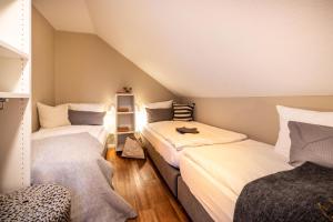 a room with two beds in a attic at Riff5 Wohnung 6 in Borkum +7 photos