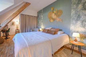 a bedroom with a large bed and a piano at Gite de l'entente in Macey
