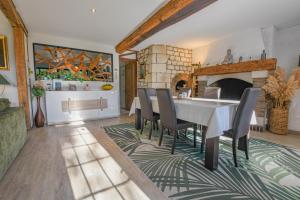 a dining room with a table and chairs and a fireplace at Gite de l'entente in Macey