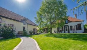 a house with a grassy yard with a pathway at Gite de l'entente in Macey