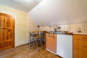 a kitchen with a white refrigerator and a counter at Chata Horec in Štrba