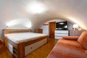 a bedroom with a bed and a couch at Chata Horec in Štrba