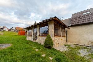 a house that is sitting in the grass at Chata Horec in Štrba